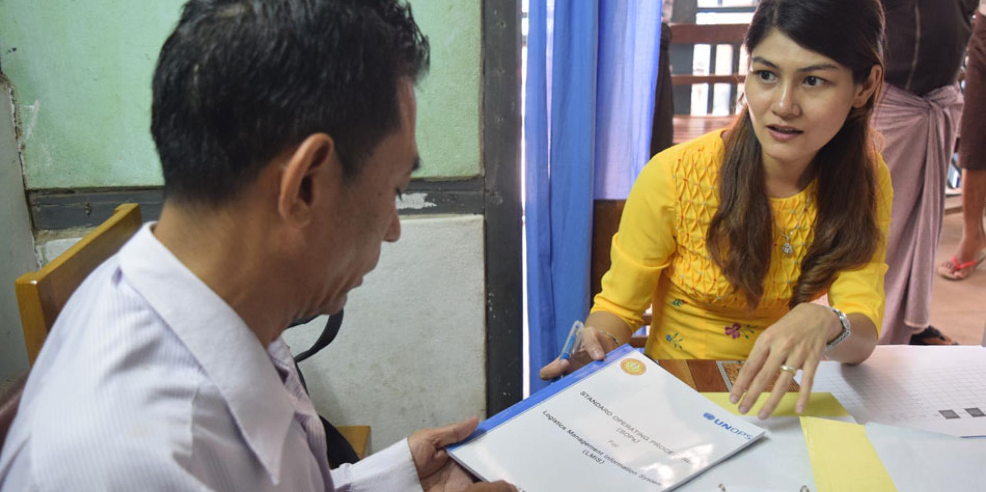 Malaria Assistant U Mya Win Than at Pakokku NMCP is given the updated LMIS manual. It helps ensure that standard logistics guidelines/manuals are in place at every storage facility of partners implementing the Global Fund grants. Malaria Assistant U Mya Win Than at Pakokku NMCP is given the updated LMIS manual. It helps ensure that standard logistics guidelines/manuals are in place at every storage facility of partners implementing the Global Fund grants.