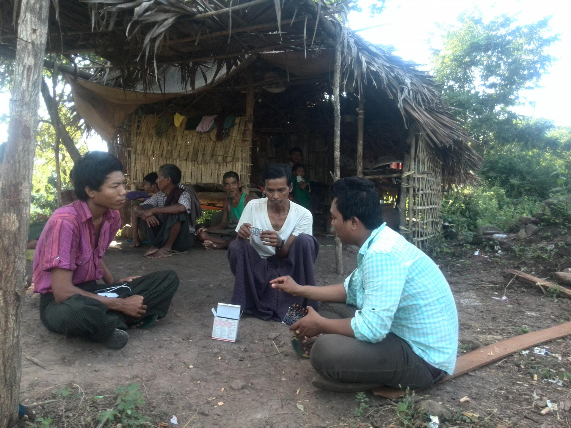 During a visit to Ko Win Zaw’s home, Ko Nay Linn checks anti-TB medicines to confirm he is taking the correct doses. Incorrect doses could delay his recovery and give rise to drug resistance. Photo: MHAA