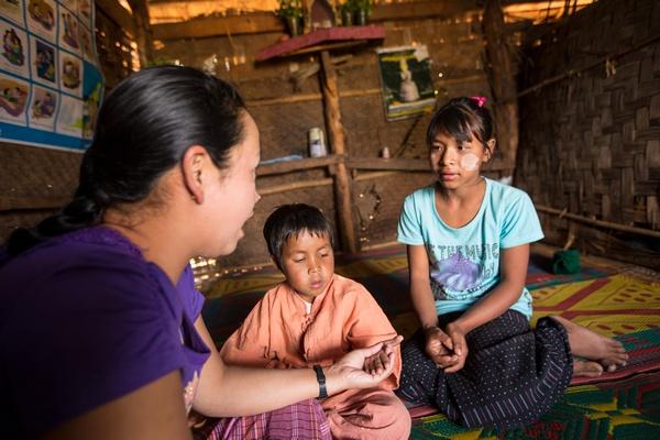 A caregiver from Pyi Gyi Khin conducts home visits to help ensure that nutritional and psychosocial support is provided.  Lwai Hat village, Aung Ban Township, Southern Shan State. Photo: John Rae/The Global Fund