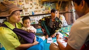 A caregiver from Pyi Gyi Khin conducts home visit to help ensure that those affected by the disease receive the nutritional and psychosocial support they need.  Lwai Hat village, Aung Ban Township, Southern Shan State. Photo: John Rae/The Global Fund