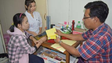Dr Lin Htoo Lwin provides advice on compliance to taking anti-TB drugs while he dispenses drugs at his private clinic in Shwe Pyi Thar Township, Yangon. Photo: MMA