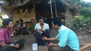 During a visit to Ko Win Zaw’s home, Ko Nay Linn checks anti-TB medicines to confirm he is taking the correct doses. Incorrect doses could delay his recovery and give rise to drug resistance. Photo: MHAA